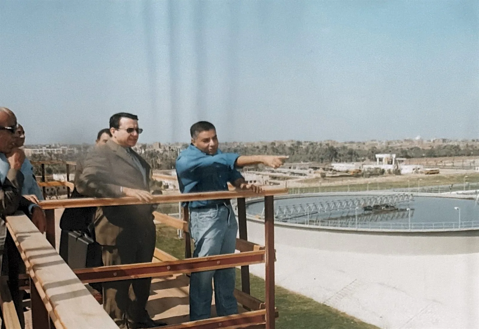 Dr. Alaa Mahmoud Al Tamimi being briefed by an engineer during a site visit